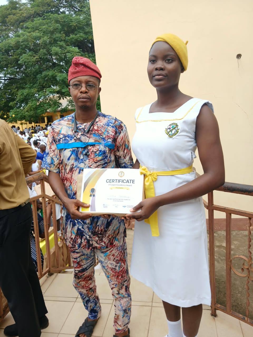 A student receives her certificate